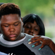 Cameron Sterling, son of Alton Sterling, is comforted as he listens to family and attorneys speak following a meeting with the U.S. Justice Department at federal court in Baton Rouge, La., Wednesday, May 3, 2017. An investigation into the police shooting death of Alton Sterling in Baton Rouge found that there was not enough evidence to prove that the white officers acted unreasonably and willfully, a federal prosecutor said Wednesday.